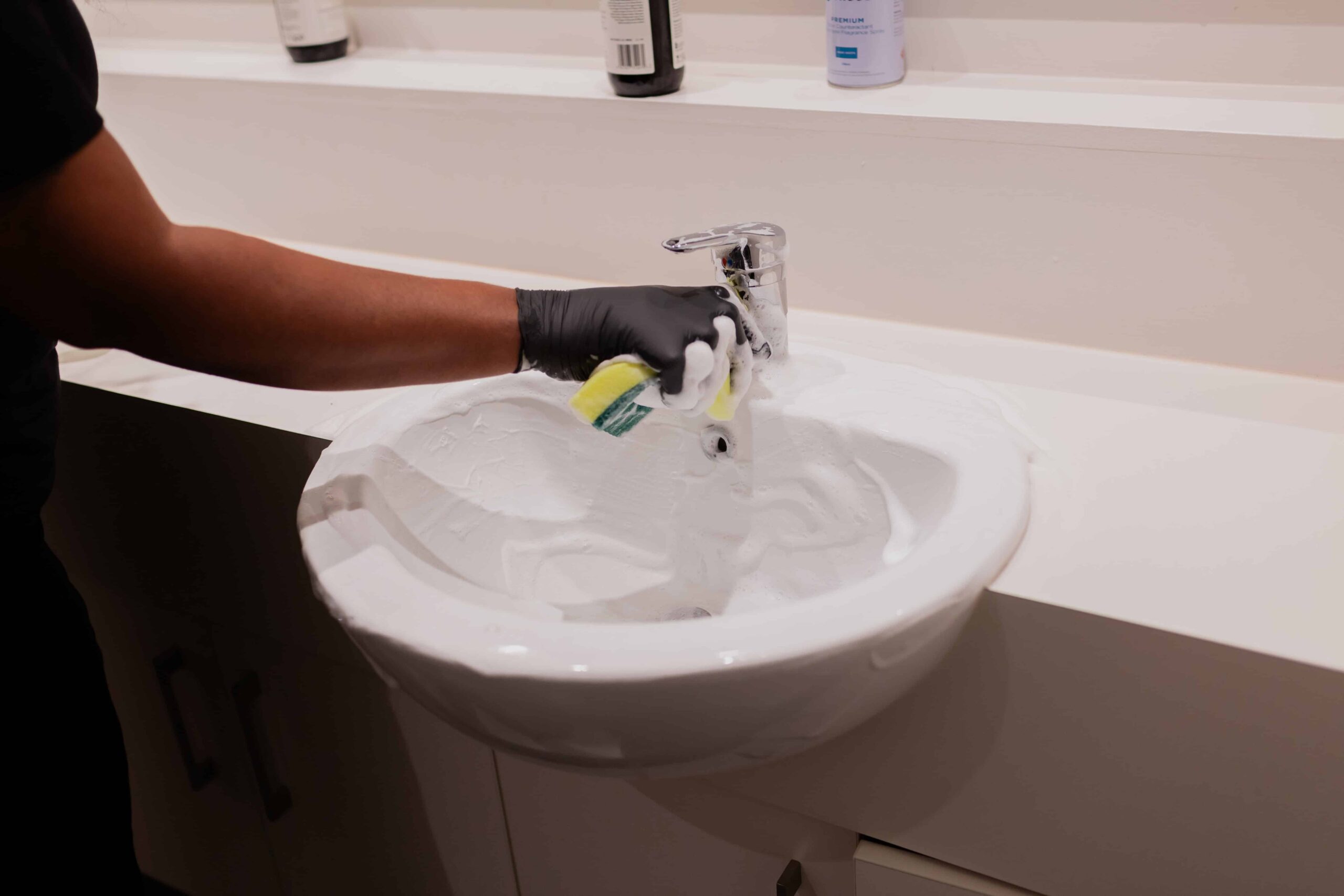 Cleaner from ACS Commercial Cleaning cleans basin